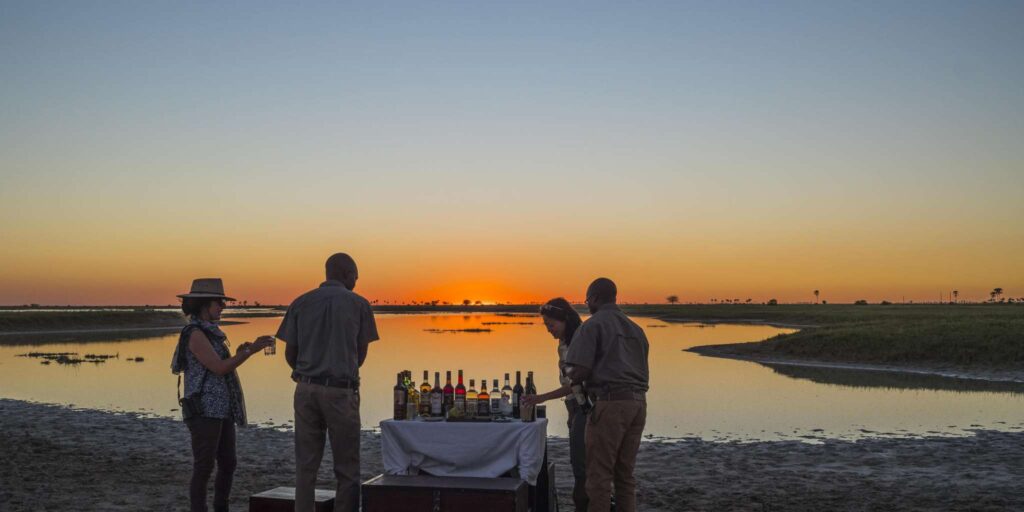 G&T sundowners by Botswana sunset