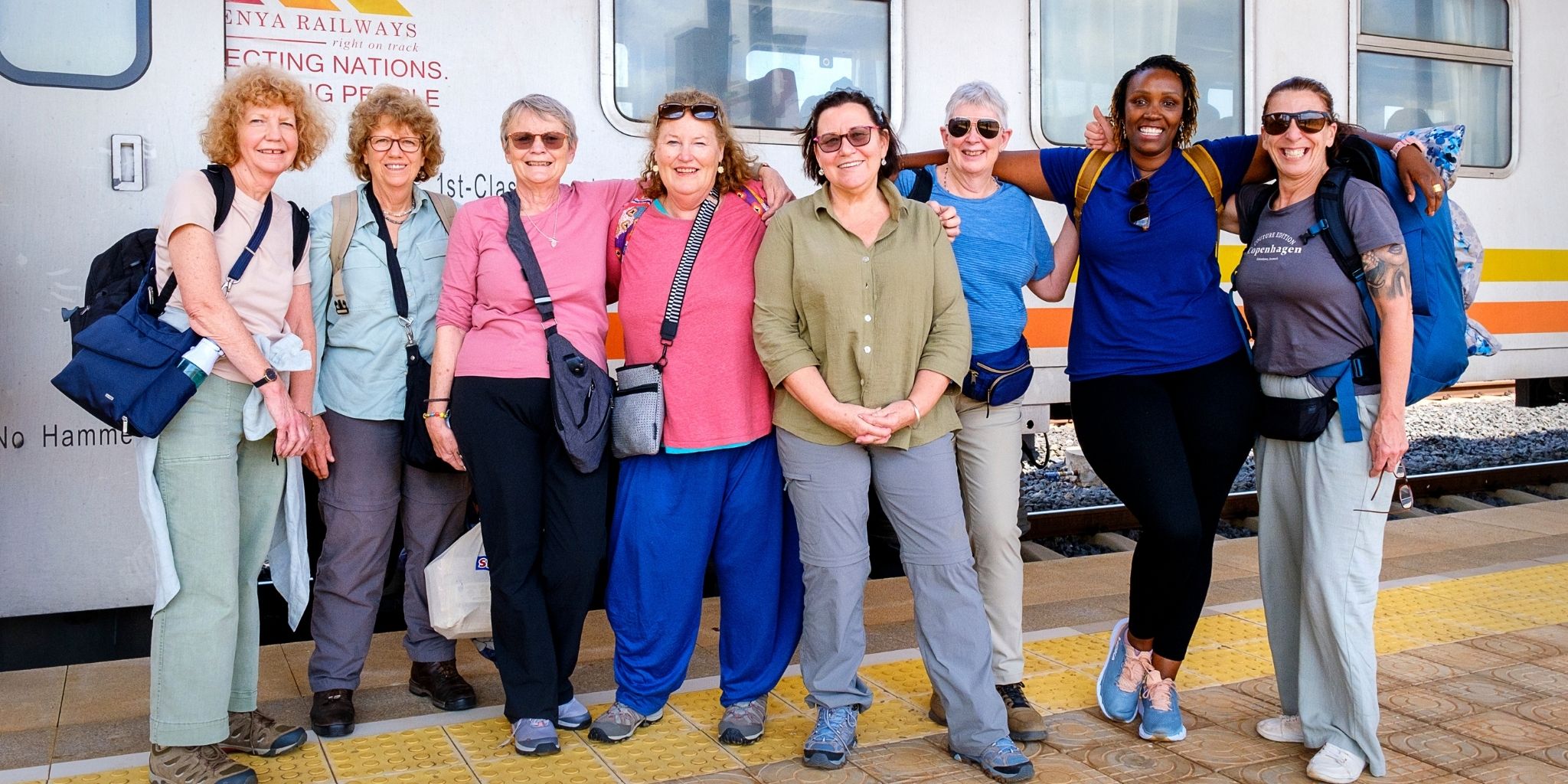 Explore Kenya women group photo at train station