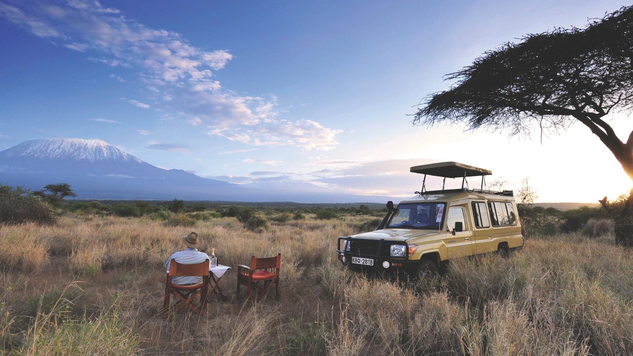 A man sitting a looking at Mount Kilimanjaro at Elerai Camp