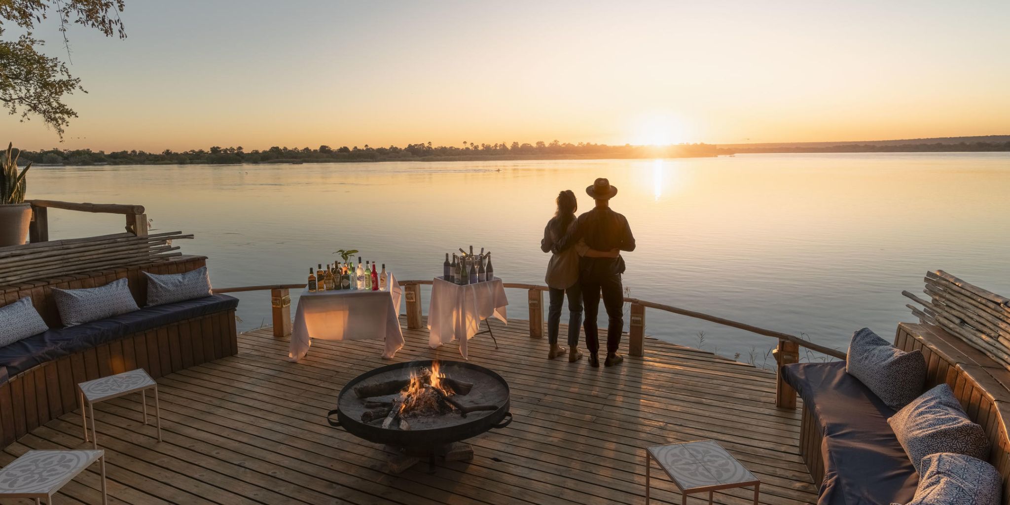 Sundowners by the water at Tongabezi Lodge