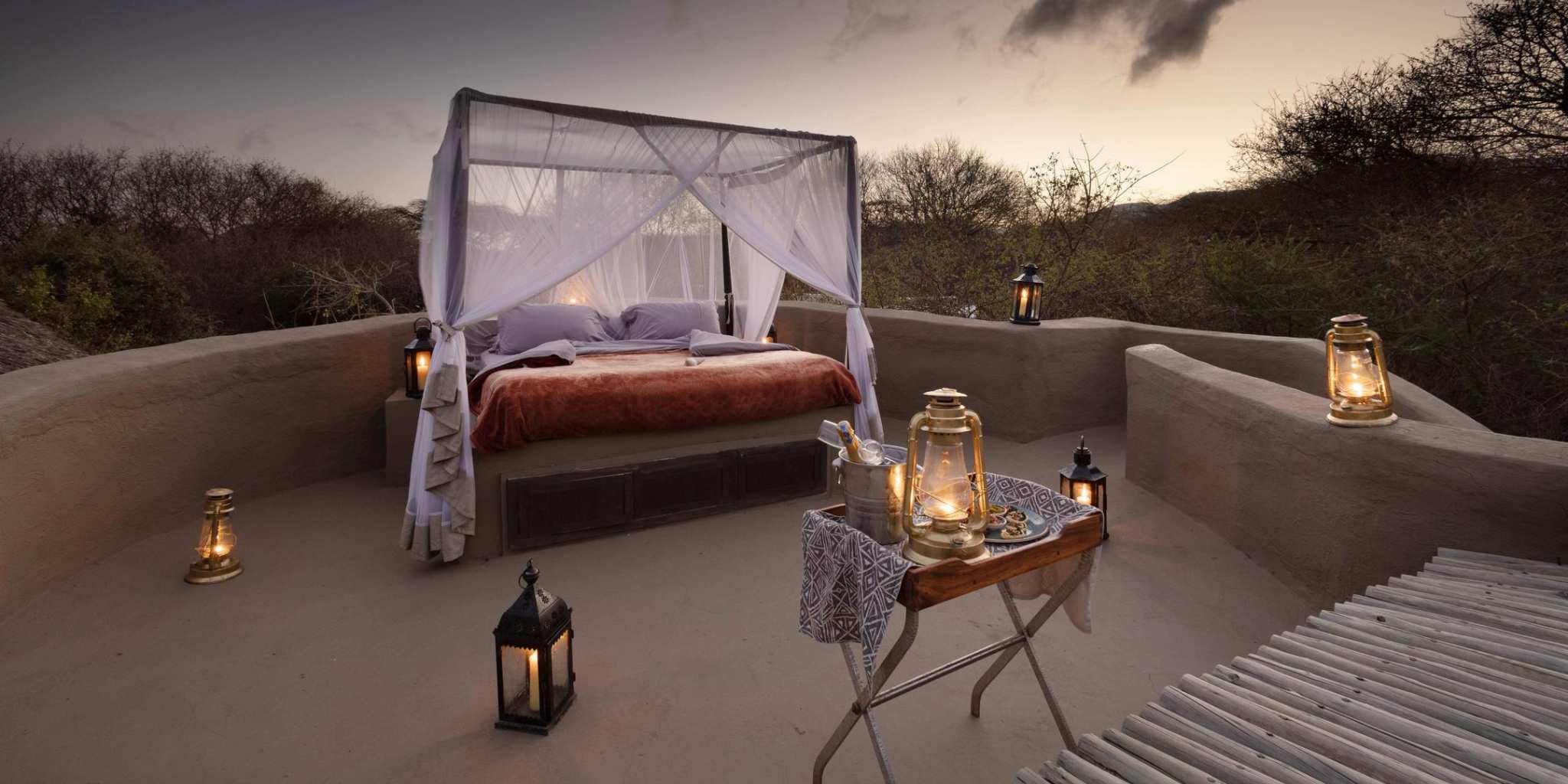 Beautifully made up bed under the stars at Ol Donyo