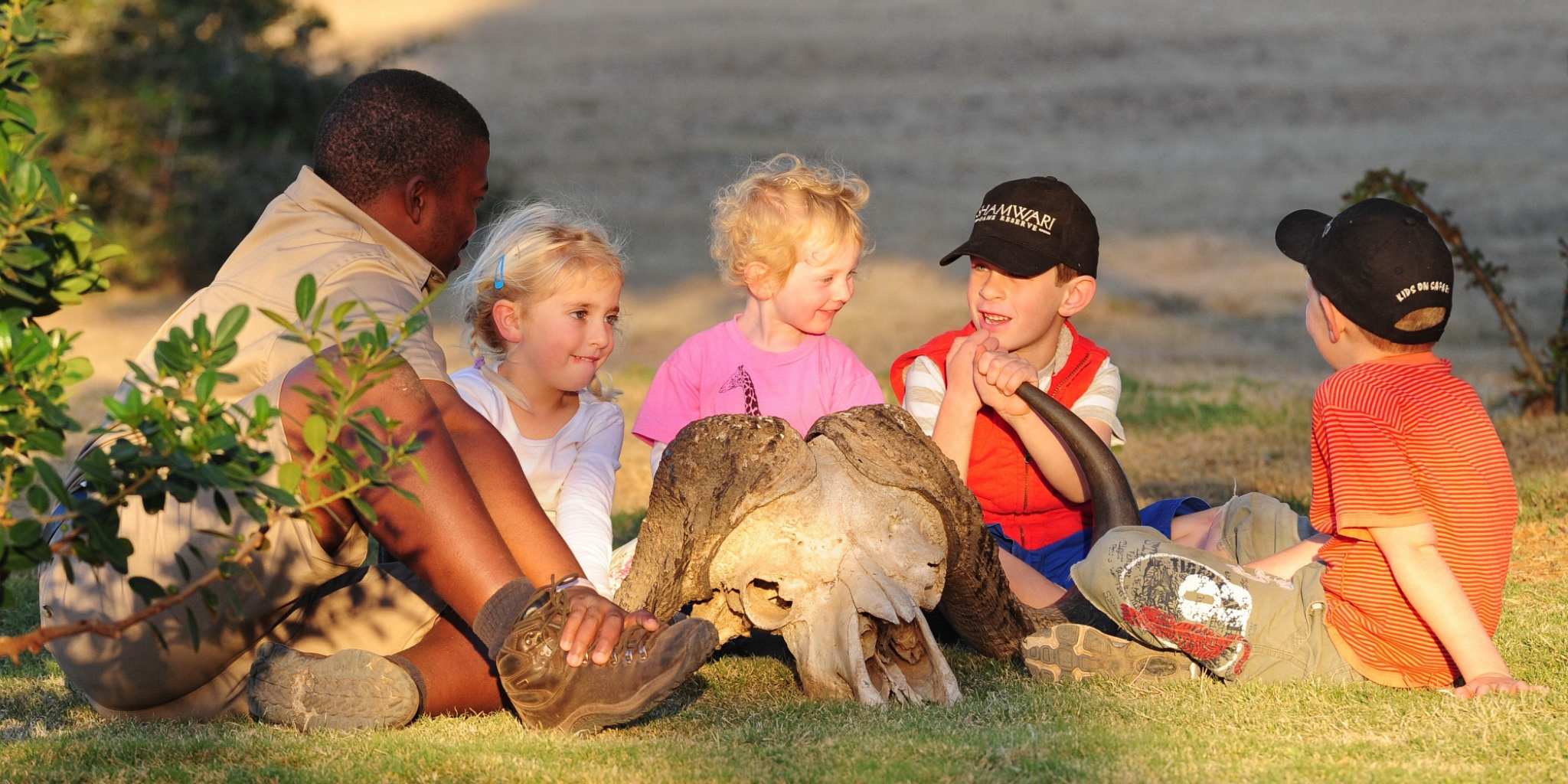 Children and a guide looking at animal skull