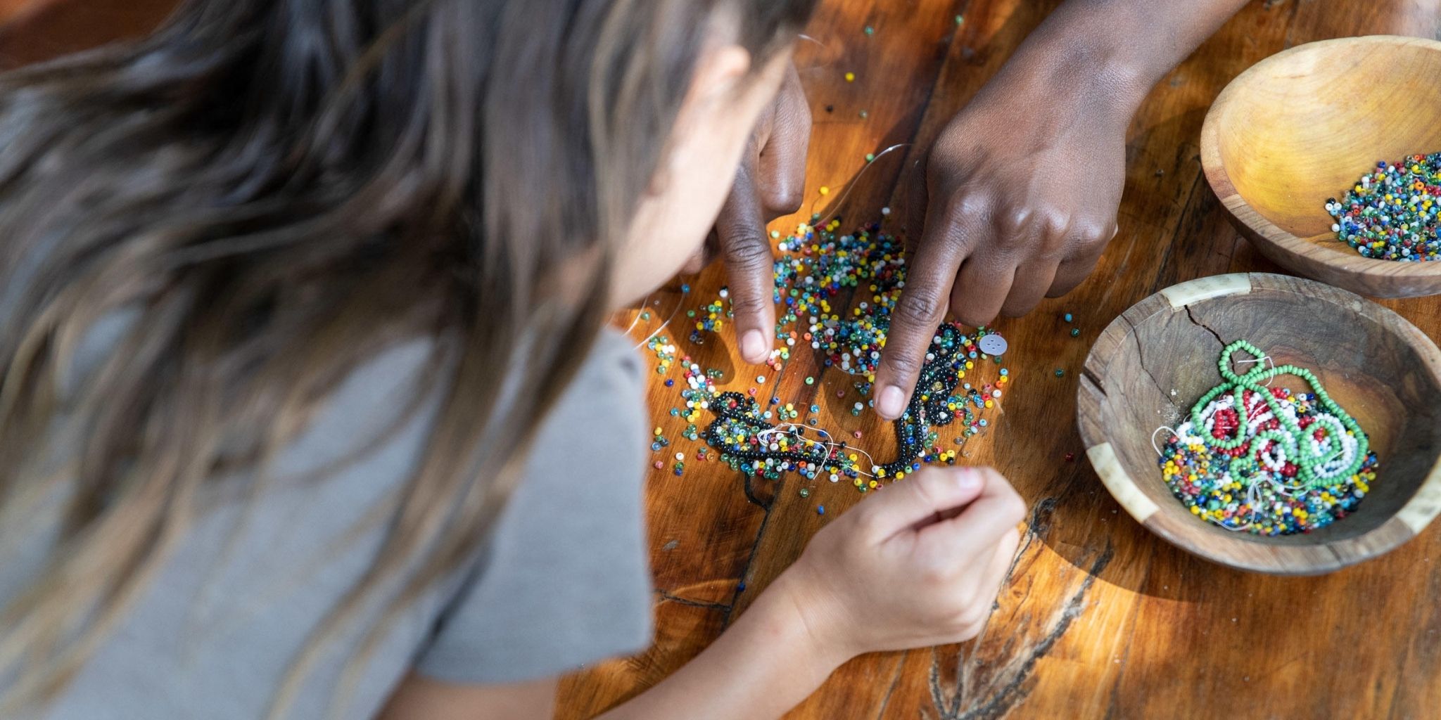 Young girl learning beading