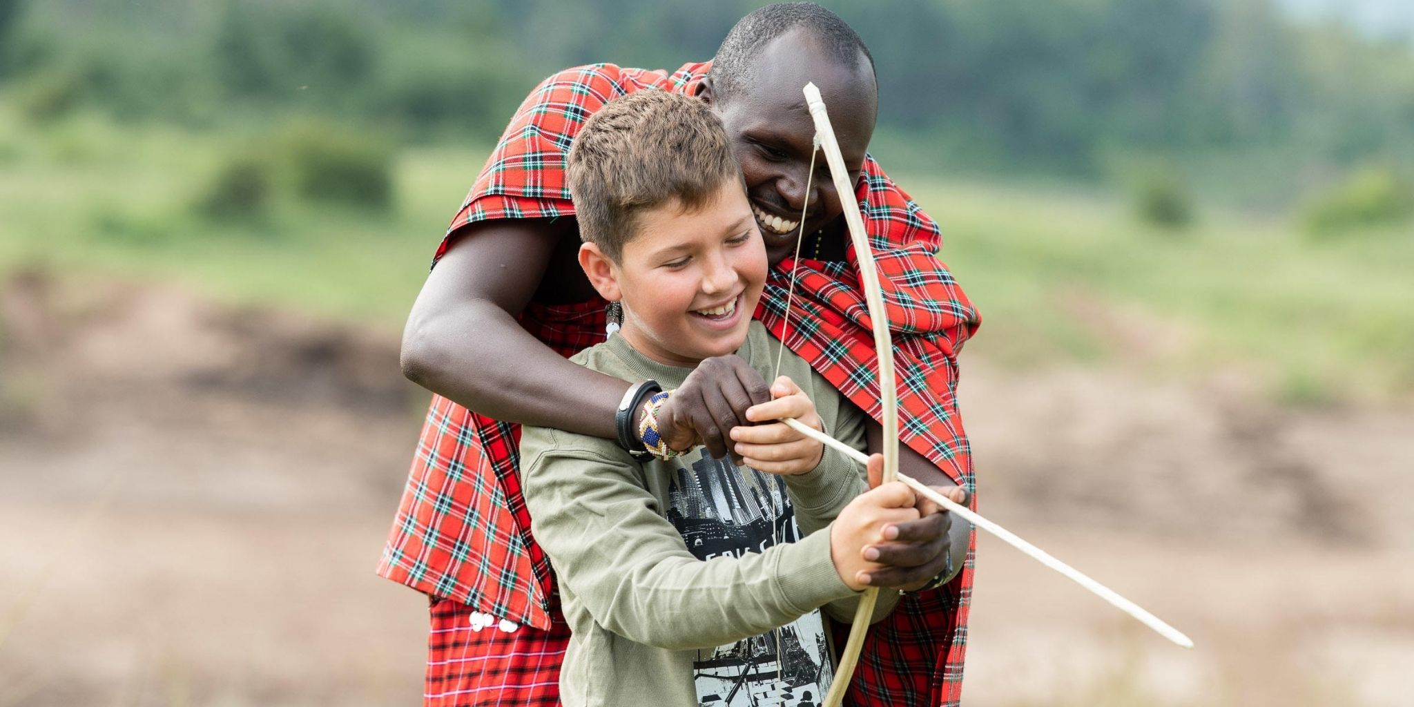 Child being taught archery at Masai Warrior School