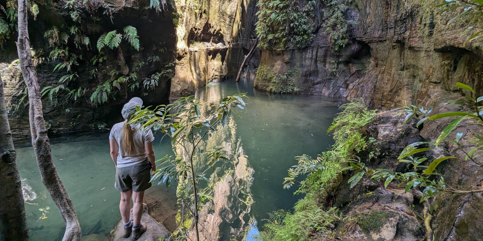 Hidden bright blue water surrounded by rocks and greenery and wildlife