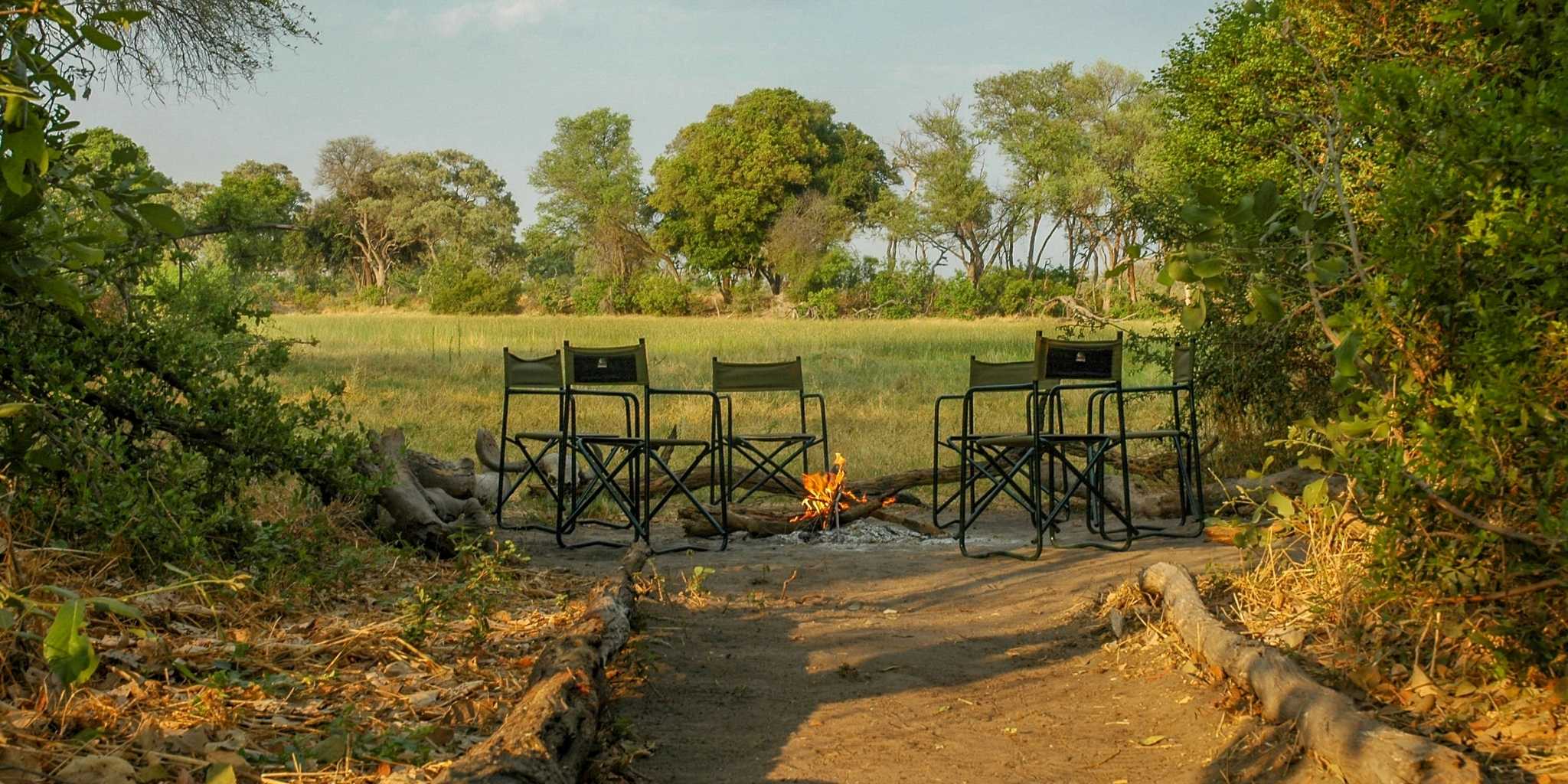 Outdoor seating area around a campfire at Kwapa training camp