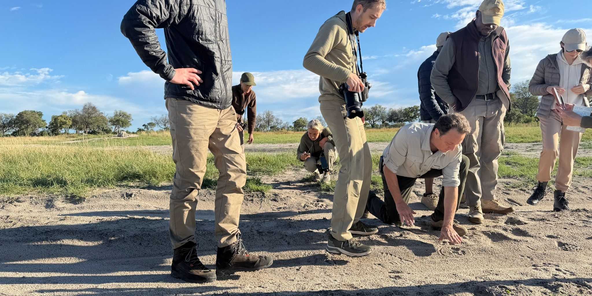 Kwapa safari school tracking lesson looking at marks in the earth