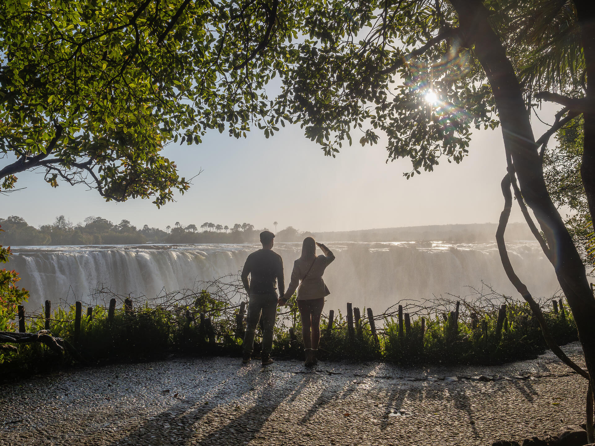 A couple looking onto the stunning and dramatic Victoria Falls waterfall