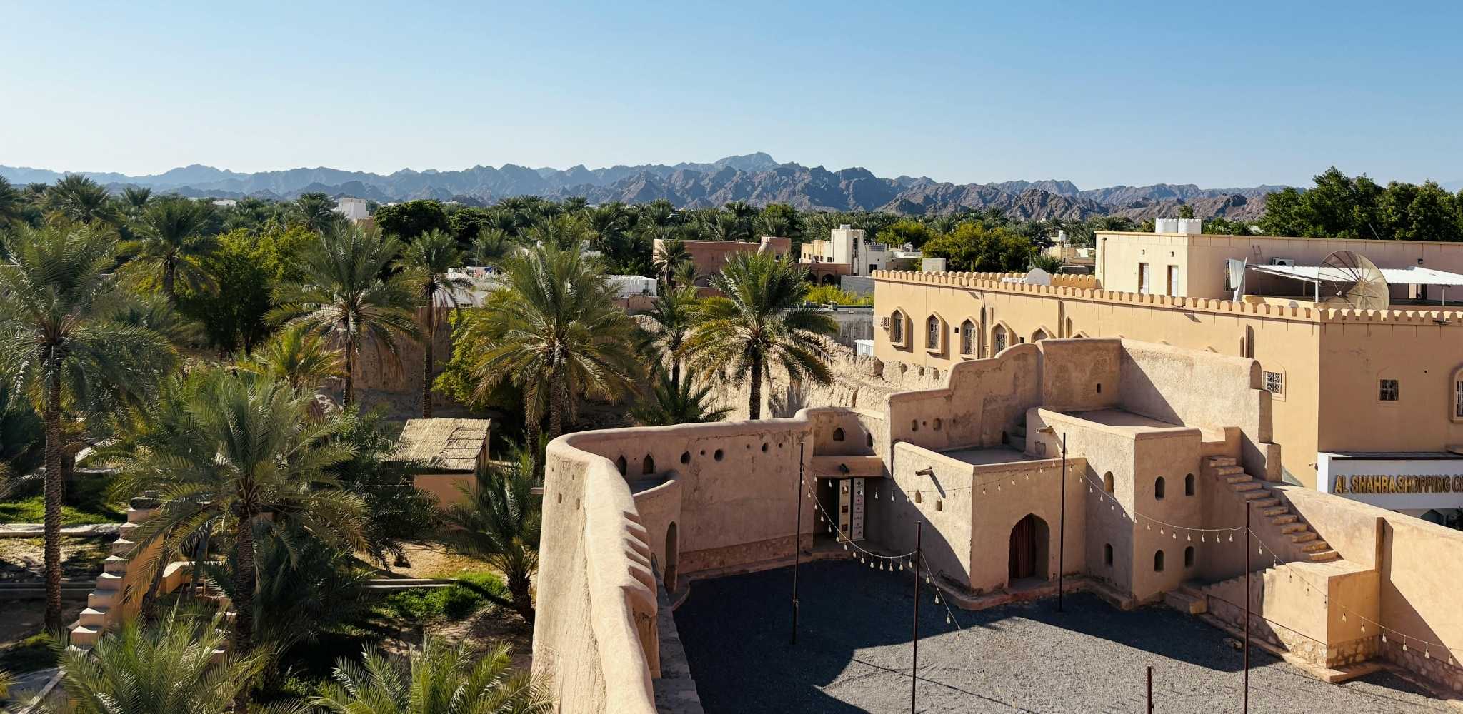 Nizwa city with gorgeous built up old yellow buildings surrounded by stunning nature